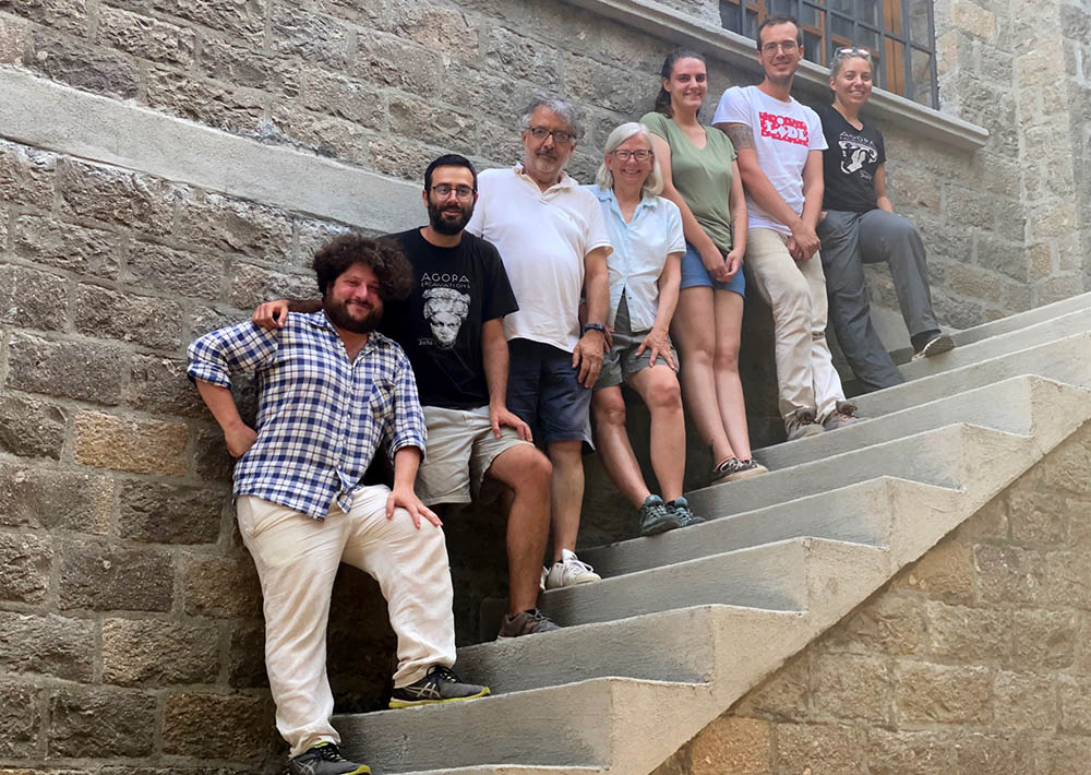 Group photo of the entire excavation team on stairs.