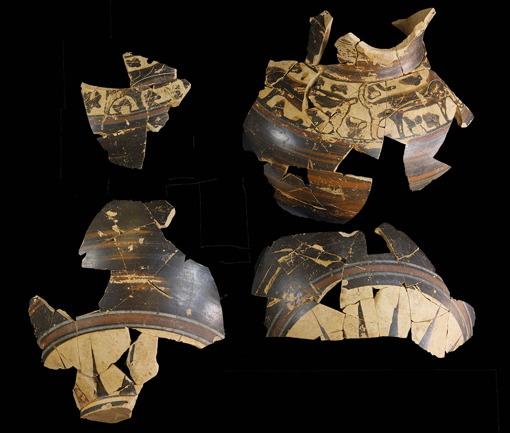 fragments of ceramic vessels, partially reassembled on a black background.