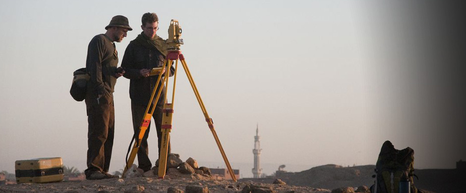 Workers taking a topographic survey of the excavation site.