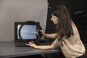 Student examining a cathode ray tube